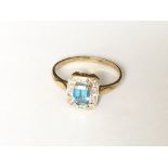 A rectangular blue topaz and diamond cluster ring