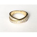 A crossover stone set ring in 9ct gold
