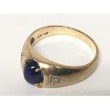 A 10k gold ring set with a blue stone cabochon and