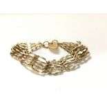 A 9ct gold gate bracelet. 7.75g