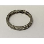 A white gold eternity ring inset with small diamon