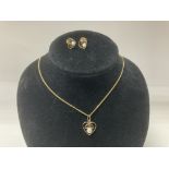 A 9ct yellow gold necklace and pendant inset with