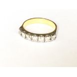 An 18ct 7 stone diamond set half hoop ring