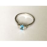 A white gold blue topaz and diamond ring