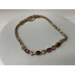 A pretty 14K yellow gold ruby and diamond bracelet