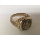 A 9carat gold ring with a raised crest. Weight 10g