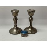 A pair of hallmarked silver candlesticks together