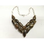A large silver and tiger's eye necklace.