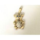 A 9ct gold stone set teddy bear pendant