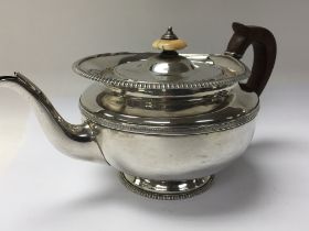 A Quality George III silver tea pot with a raised gadrooned edge ivory finial. Makers marks WD RS