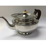 A Quality George III silver tea pot with a raised gadrooned edge ivory finial. Makers marks WD RS