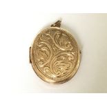 A double sided engraved oval 9ct gold locket