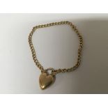 A 9carat gold chain bracelet with a heart shaped c