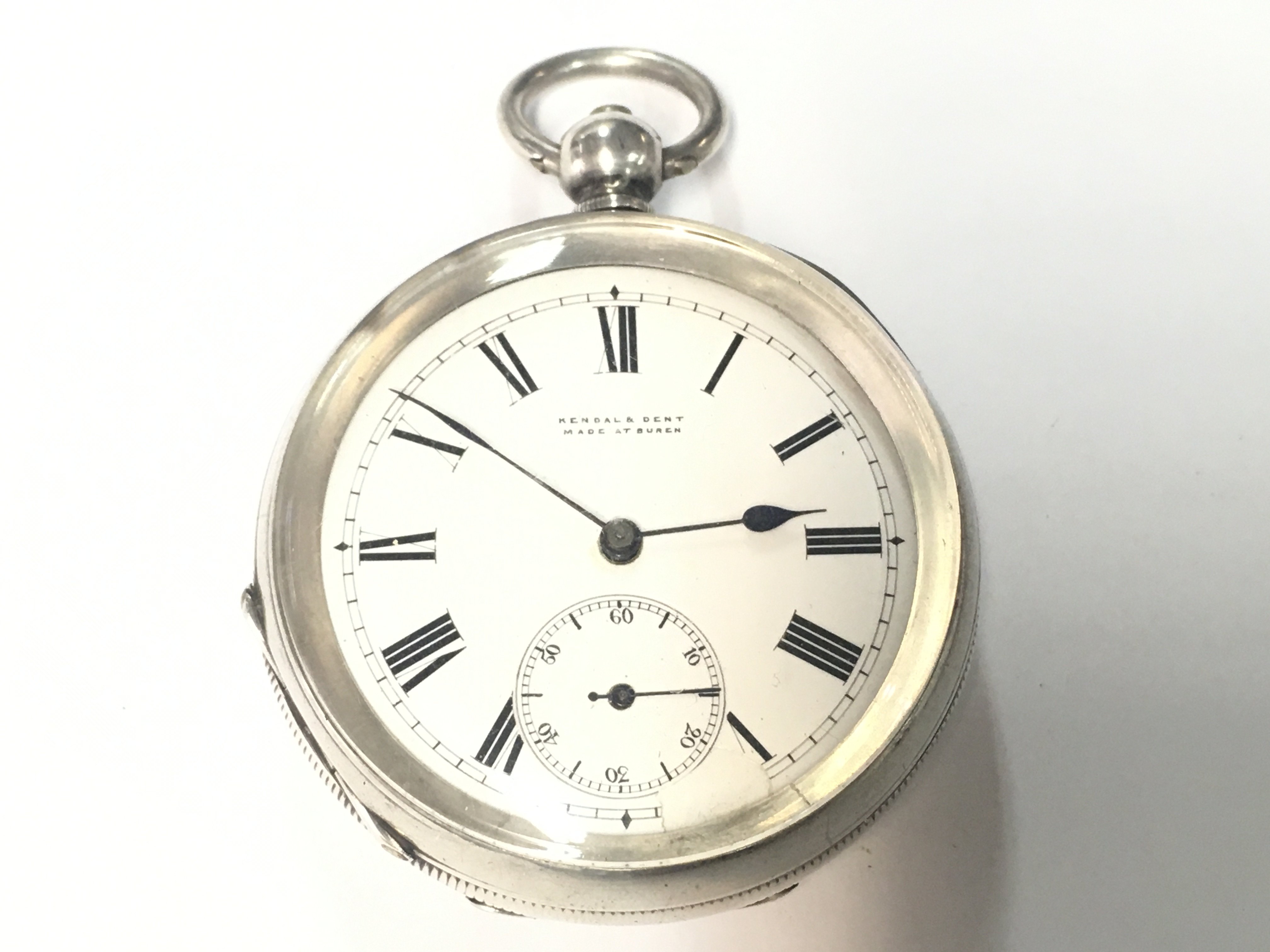 A silver pocket watch by Kendal & Dent