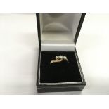 A 9ct gold ring set with three diamonds, approx 3.
