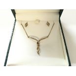 A 9ct gold necklace and earring set.