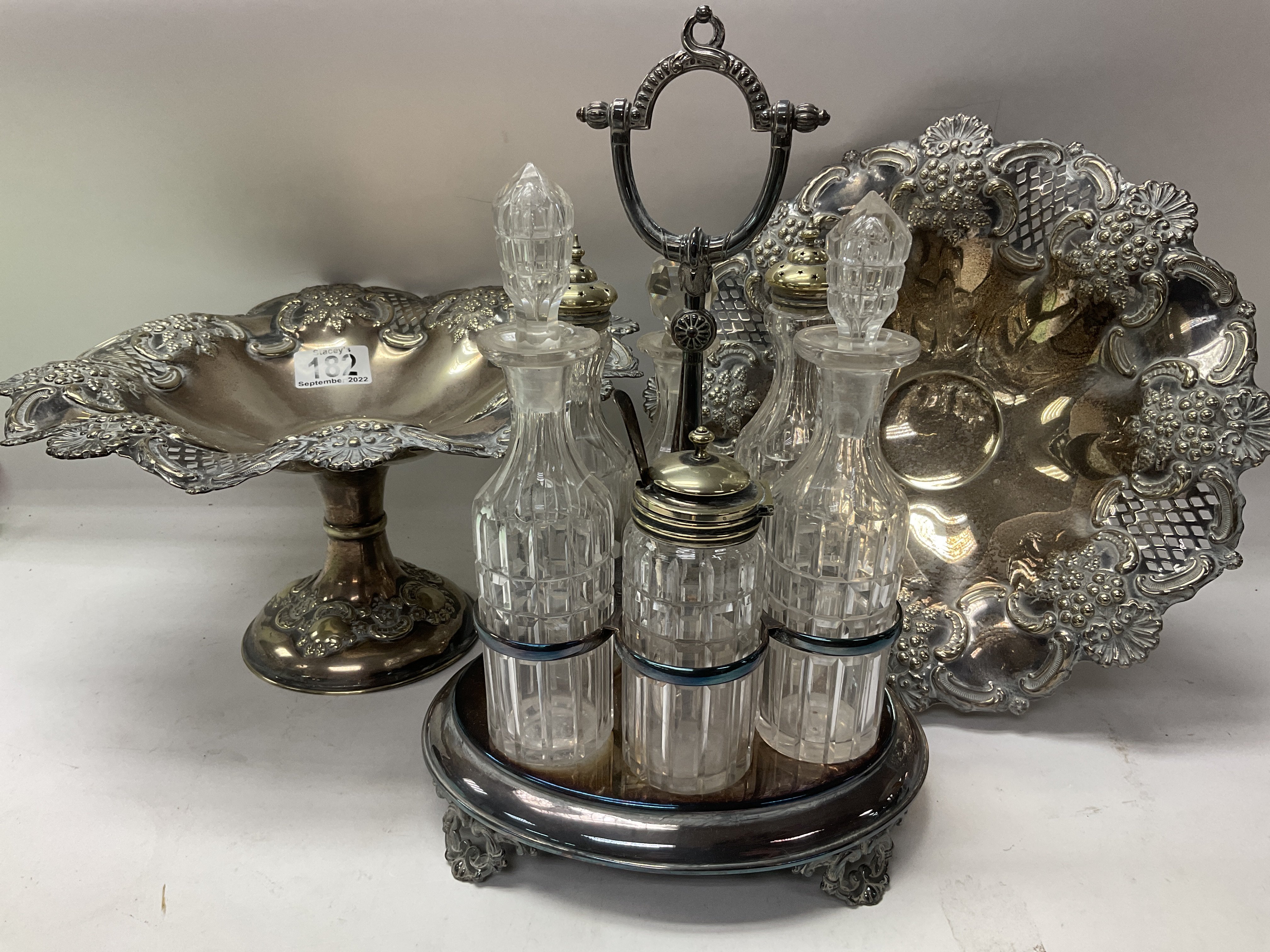 2 silver plated taza as and a silver plated 6 bottle set.