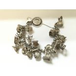 A silver charm bracelet with a large number of cha