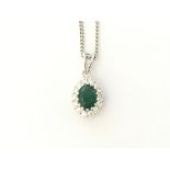 18ct white gold pendant set with an oval emerald a