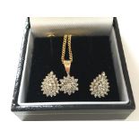 A 9ct gold diamond necklace and earring set.