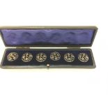A set of 6 silver buttons in case. Each button is