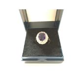 An 18ct diamond and amethyst ring. Size O 1/2 and