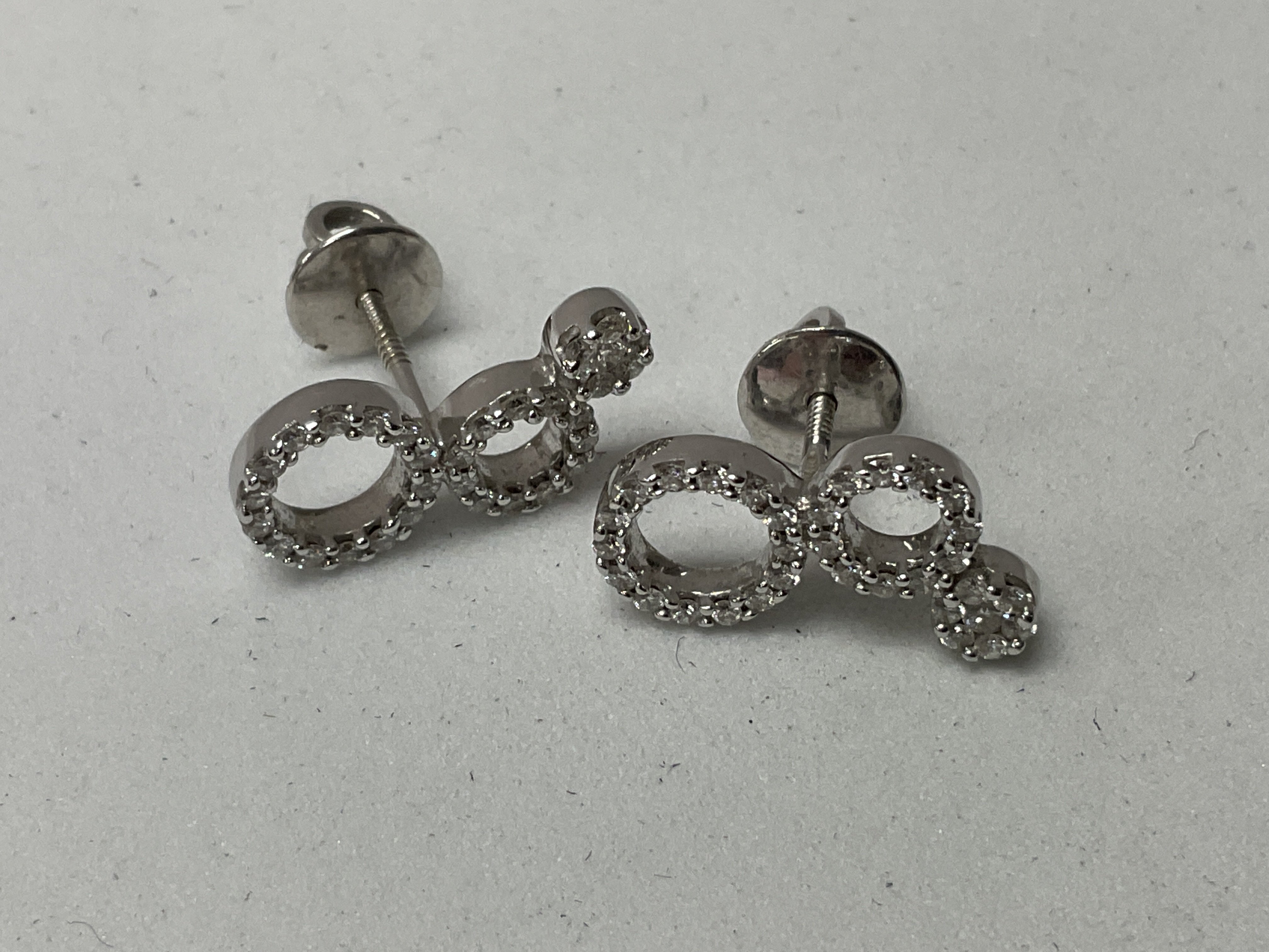 A pair of 18ct white gold and diamond set illusion