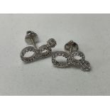 A pair of 18ct white gold and diamond set illusion
