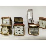 A collection of Vintage traveling alarm clocks and