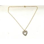 A 9ct gold and diamond heart pendant on a chain. 5