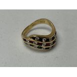 An 18ct gold ring set with 3 rows of mixed diamond
