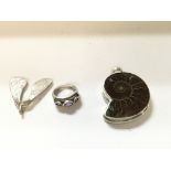 Two silver pendants and a ring set with purple sto