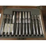 A cased set of fruit knives and forks .