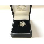 An 18ct gold diamond cluster ring. M 1/2 and 4.5g