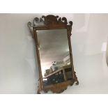 Old carved shaped walnut wall mirror