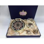 A boxed Royal Crown Derby miniature tea set.