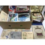 A box of wooden jigsaw puzzles, cigarette cards an