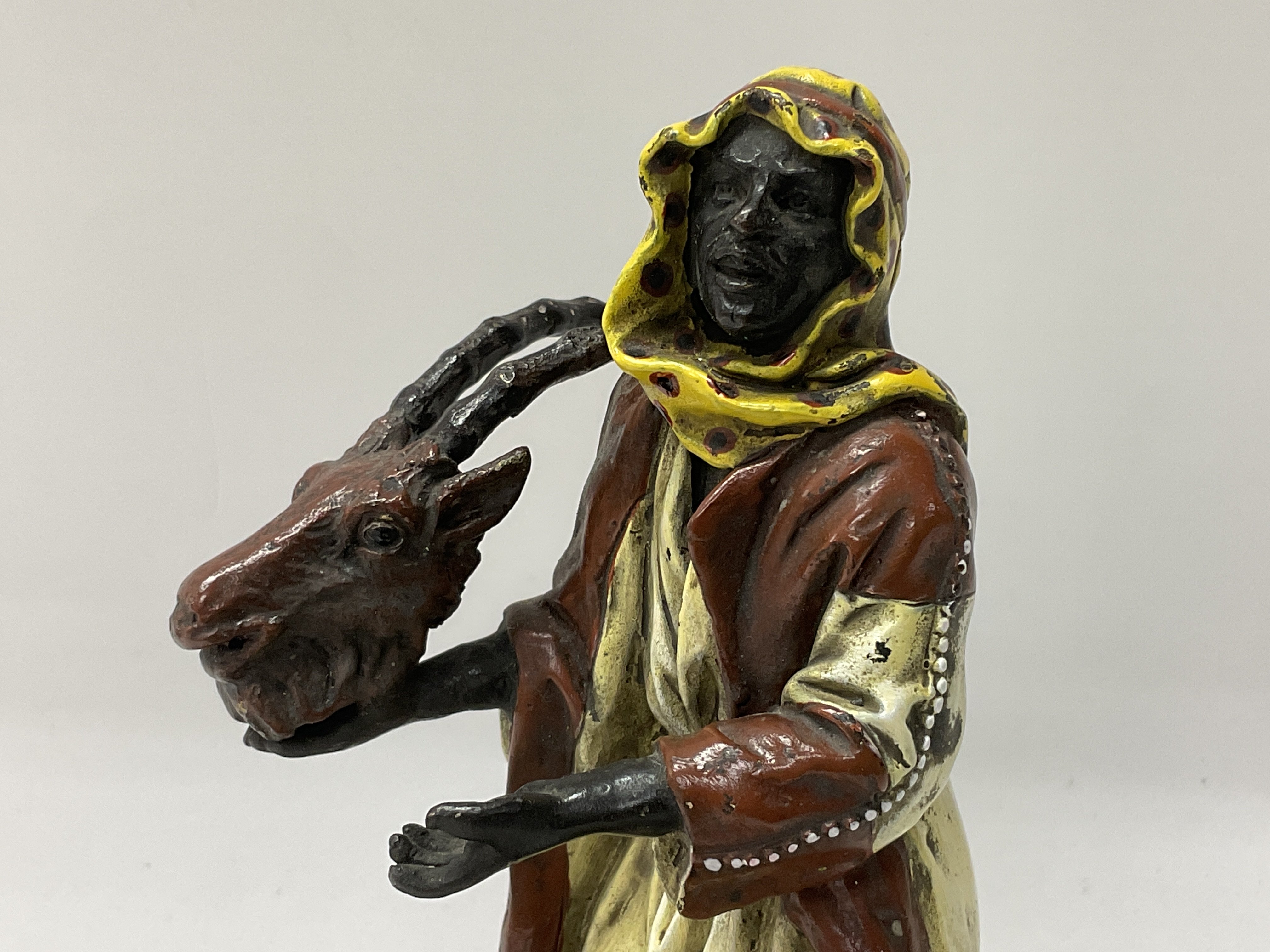 A cold painted bronze Arab figure holding a rams h - Image 2 of 7