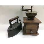 A vintage coffee grinder and a cast iron flat iron