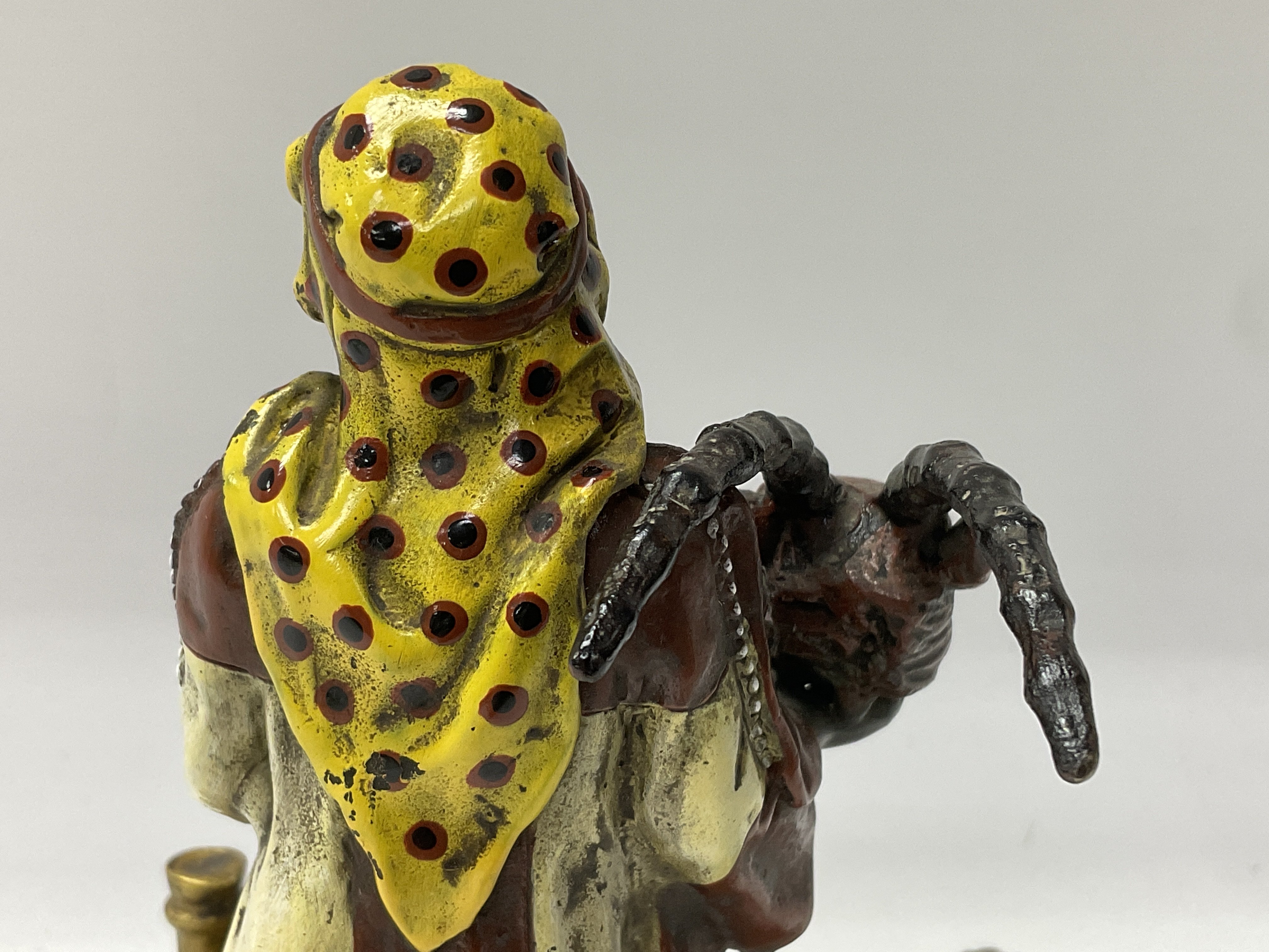 A cold painted bronze Arab figure holding a rams h - Image 6 of 7