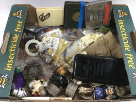 A box of various items including a vintage teethin