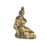 A Bronze Figure of a resting Guanyin with gilt fin