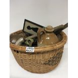 A basket containing vintage kitchen implements bra