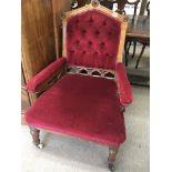 A Victorian Oak Gothic design arm chair with red b