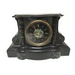 A black slate and marble mantel clock fitted with