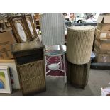 A Lloyd Loom table two linen baskets a cabinet and