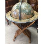 A wooden globe the the revolving and hinged top en