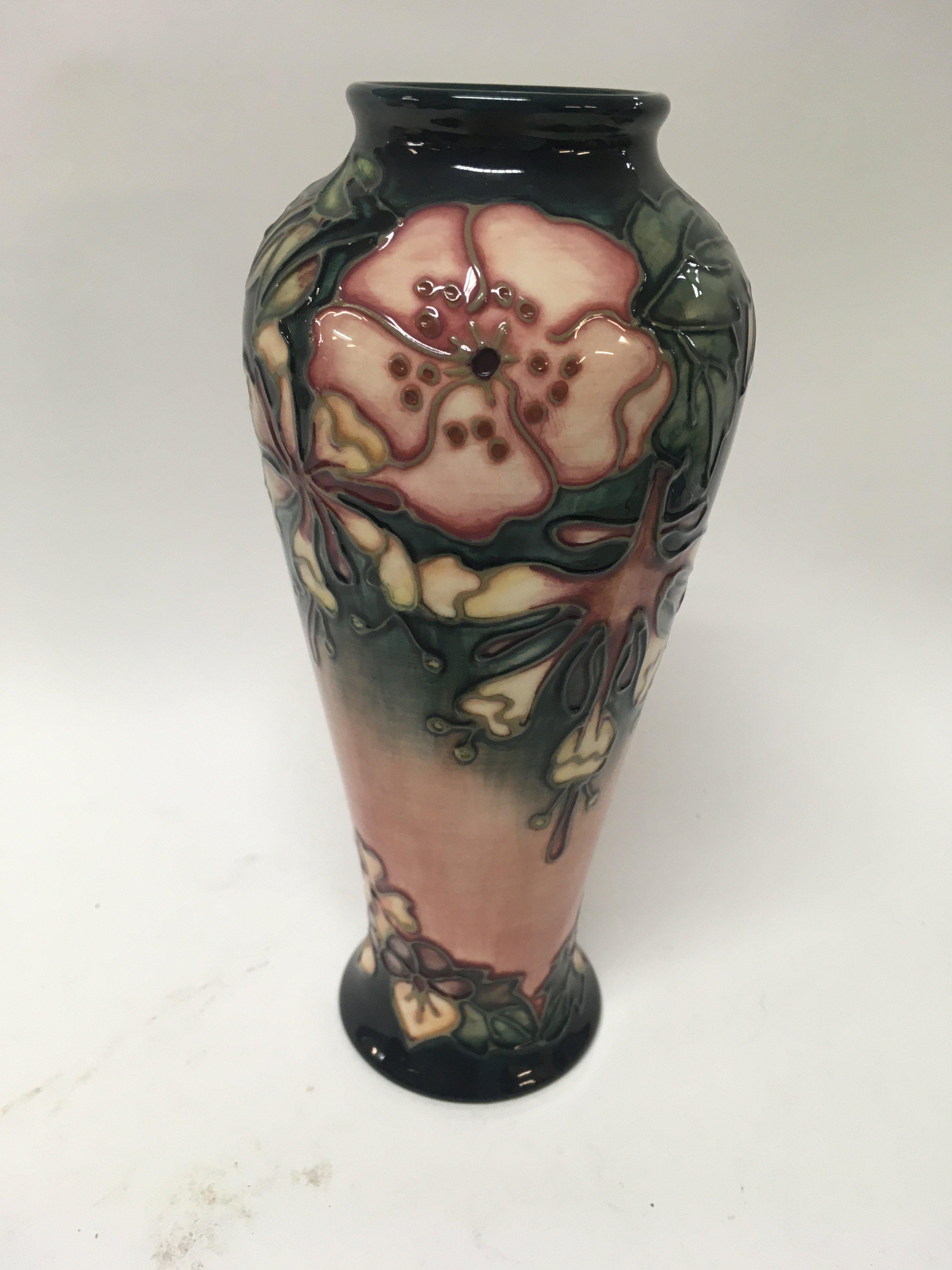 A Moorcroft vase decorated with flowers and foliag