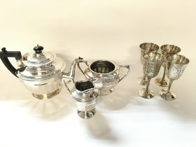 Silver plated tea set and four goblets.