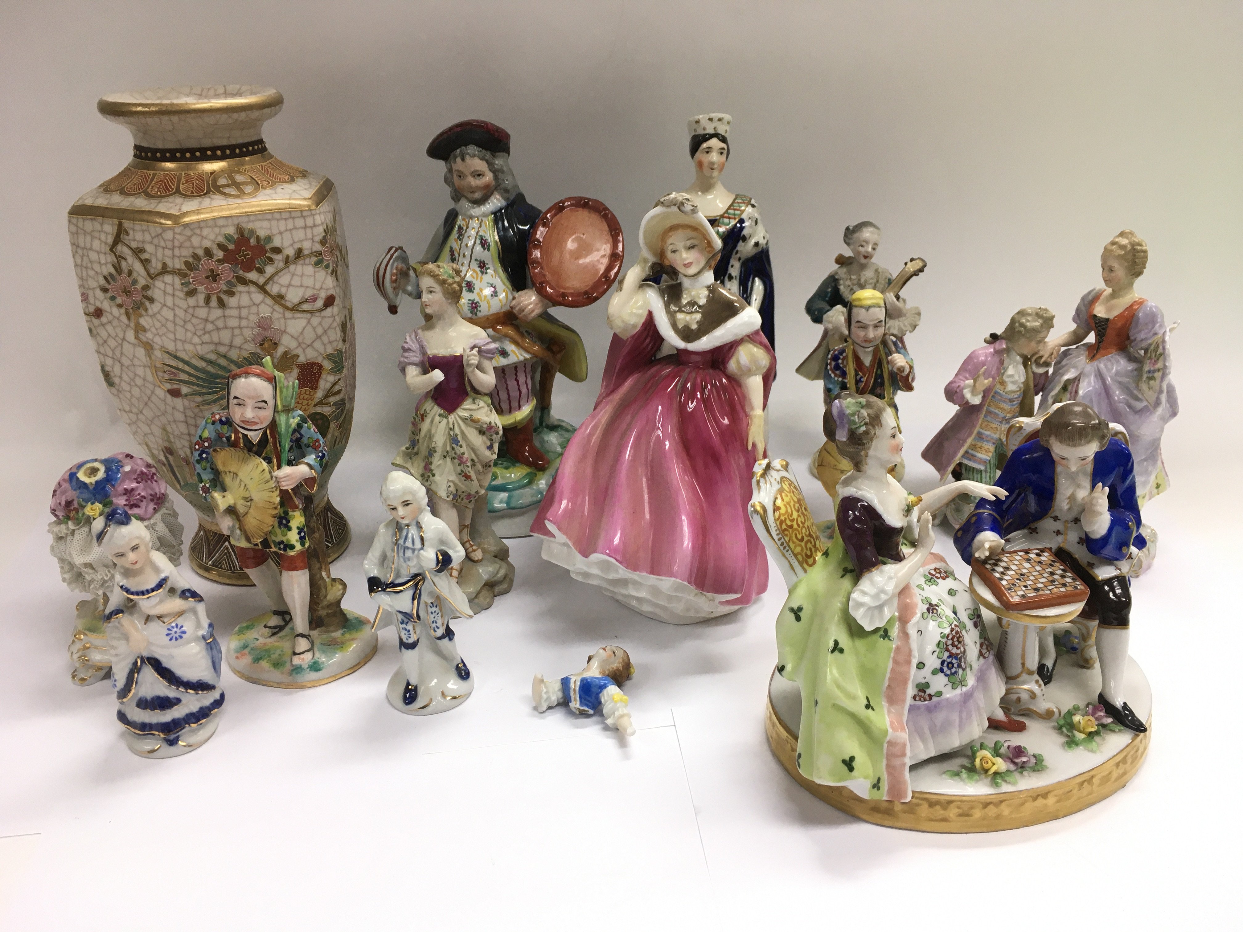 A box of ceramics comprising mainly figurines.